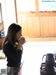 A woman sitting at a table with a cup of coffee.